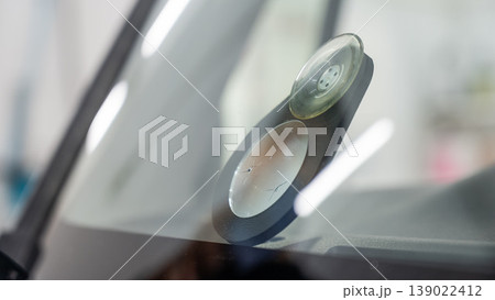 Repairing a chip on a car windshield. Repairing a chip on a car windshield. 139022412