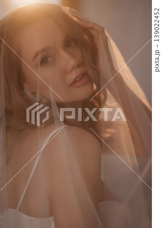 Closeup Photograph Capturing Emotional Expression Of Bride Through Delicate Veil And Gentle Lighting 139022452