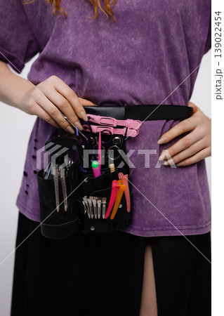 Close up of hairstylist tools belt with scissors and clips isolated on white background Close up of hairstylist tools belt with scissors and clips isolated on white background 139022454
