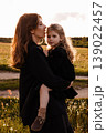 Sunset Walk With Family Members. Serene Family Scene During Sunset In Vast Grassy Landscape 139022457