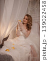 Refined Studio Scene Showcasing Tranquil Bride Embraced By Sparkling Beads And Delicate Drapery 139022458