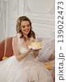 Bridal Cake Celebration. Joyful Bride Beams While Holding Cake With Twinkle Reflections 139022473