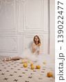 Woman On Tiles Playing With Fruit. Candid Scene Of Bride Enjoying Citrus Amid Retro Decor 139022477