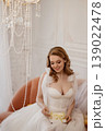 Joyful Wedding Display. Luminous Bride Showcasing Delicate Cake With Charming Accessories 139022478