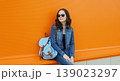 Young woman with backpack , modern teenage girl posing on city street 139023297