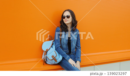 Young woman with backpack , modern teenage girl posing on city street 139023297