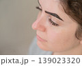 Caucasian woman getting eyebrow tinting procedure.  139023320
