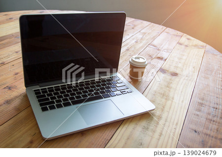 Laptop with tablet and a cup of fresh coffee on wooden table 139024679