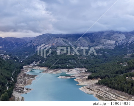 Serene Valley With Tranquil Waters, Elevated Perspective Showing Rugged Cliffs And Placid Waters Serene Valley With Tranquil Waters, Elevated Perspective Showing Rugged Cliffs And Placid Waters 139024923