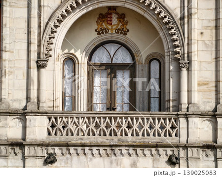Decorative Arched Window Structure. Ornate Stone Balcony Featuring Arched Window And Decorative Crest 139025083