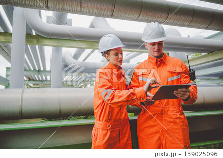 Oil and Gas Engineers Reviewing Operational Plans at Pipeline Section of Refinery Plant 139025096