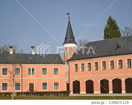Charming Courtyard With Towers. Terracotta Walls And Symmetrical Garden Create Inviting Atmosphere 139025129