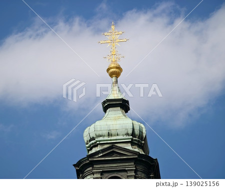 Luminous Atmosphere Surrounds Patinaed Copper Dome With Gilded Accents Beneath Drifting Clouds 139025156