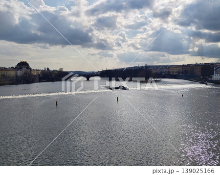 Sunshine Reflecting On Tranquil River With Dramatic Cloudy Background And Distant Bridge Crossing Sunshine Reflecting On Tranquil River With Dramatic Cloudy Background And Distant Bridge Crossing 139025166