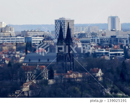 Gothic Tower Soars. Imposing Gothic Church Steeple Surpasses Surrounding Buildings With Intricate Stonework Gothic Tower Soars. Imposing Gothic Church Steeple Surpasses Surrounding Buildings With Intricate Stonework 139025191