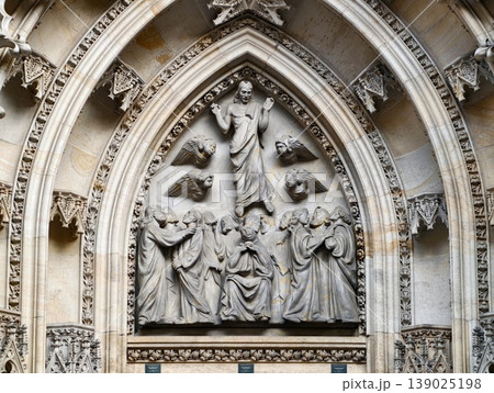 Ornate Gothic Stone Relief Showcasing Christ Enthroned Amid Apostles And Carved Saints With Aged Patina 139025198