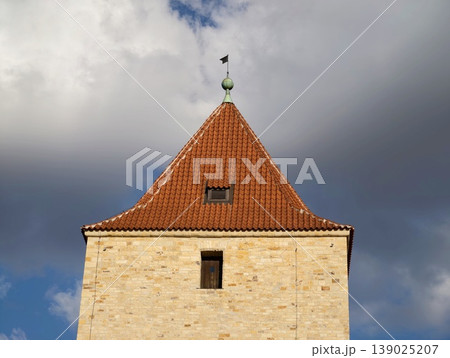 Ancient Tower Scene. Old Stone Edifice Featuring Weather Vane And Textured Masonry Surface 139025207