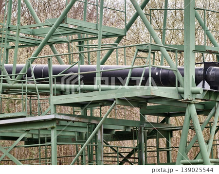 Industrial Pipe Pathway. Robust Green Platform Supports Insulated Piping With Industrial Fittings 139025544