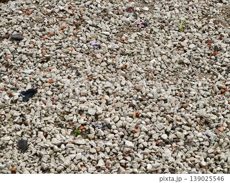 Pebbles With Debris. Detailed View Of Tiny Sandcolored Stones Mixed With Plastic Pieces And Colorful Waste 139025546