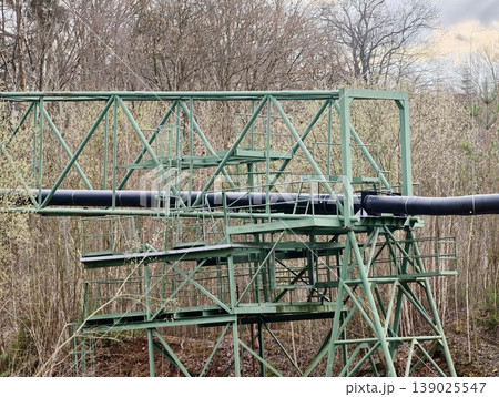 Old Pipeline System Standing Amidst Leafless Woods Under Gloomy Sky Evoking Resilience And Decay 139025547