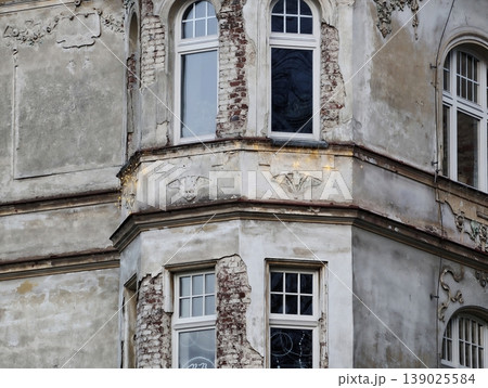 Facade Of Ornate Building Showcasing Fractured Stucco And Aged Decorative Features For Assessment 139025584