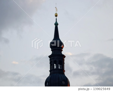 Historic Towers And Vibrant Sky. Traditional Steeples Stand Out Against Atmospheric Overcast Skies 139025649