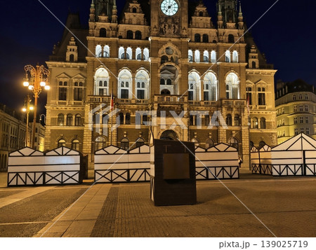 Serene Night Setting Showcasing Illuminated City Hall With Decorative Windows And Atmospheric Street Ambiance Serene Night Setting Showcasing Illuminated City Hall With Decorative Windows And Atmospheric Street Ambiance 139025719