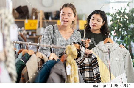 Two women choosing jackets in a clothing store 139025994