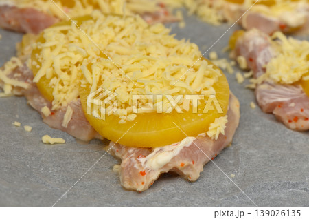 Delicious preparation of chicken topped with pineapple and cheese on a baking Delicious preparation of chicken topped with pineapple and cheese on a baking 139026135
