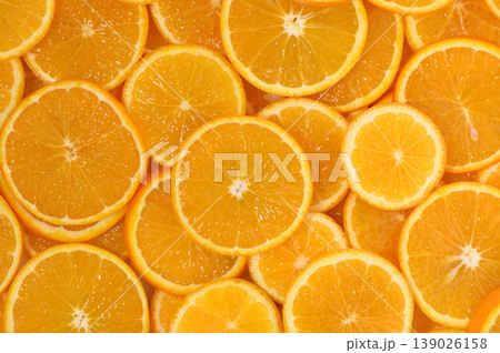Freshly sliced oranges arranged beautifully on a surface inviting vibrant Freshly sliced oranges arranged beautifully on a surface inviting vibrant 139026158