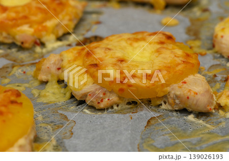 Delightful baked chicken topped with pineapple and melted cheese creating savory Delightful baked chicken topped with pineapple and melted cheese creating savory 139026193
