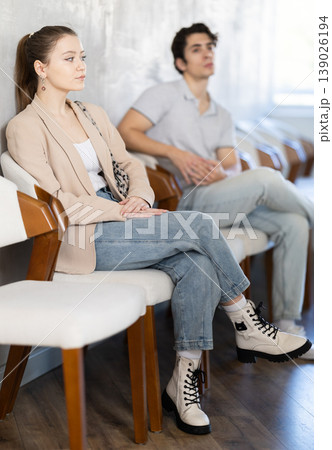 Young guy sitting in a queue at a modern office 139026194
