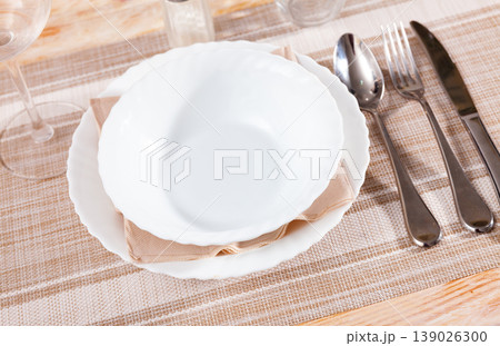 Dishes are prepared for meals on wooden table. 139026300