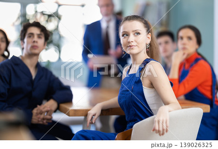 Young girl watching presentation while sitting with classmates in classroom Young girl watching presentation while sitting with classmates in classroom 139026325