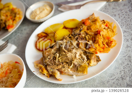 Grilled pork slices with roasted potato and braised cabbage 139026528