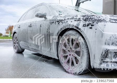 Car covered with foam during washing process at self service cleaning station 139027568