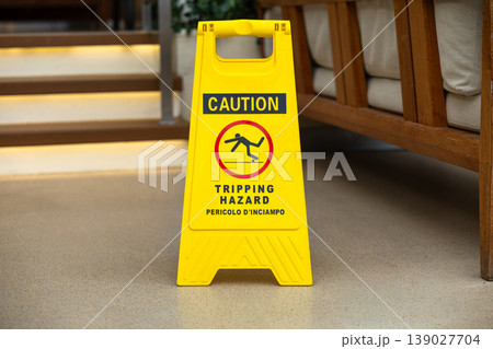 Yellow Caution Tripping Hazard Sign Near Staircase Indoor Safety Prevention Concept Yellow Caution Tripping Hazard Sign Near Staircase Indoor Safety Prevention Concept 139027704