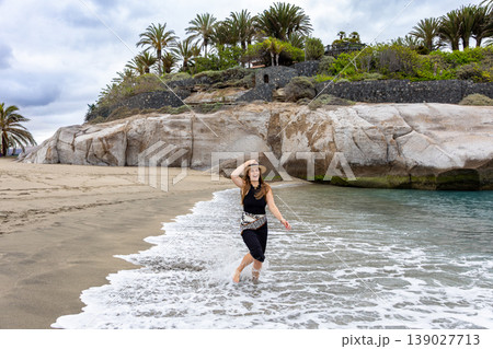 Cheerful Woman Running Through Sea Waves On Tropical Beach Adventure Cheerful Woman Running Through Sea Waves On Tropical Beach Adventure 139027713