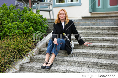 Modern Stylish Woman Relaxing On Outdoor Steps Near Residential Building Modern Stylish Woman Relaxing On Outdoor Steps Near Residential Building 139027777