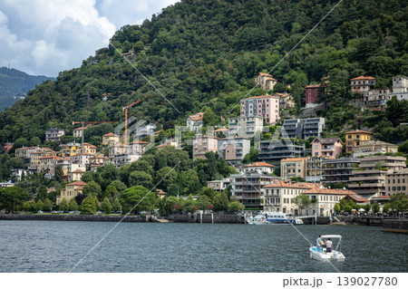 Scenic Lakeside Town with Colorful Houses and Forested Mountain Landscape 139027780