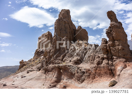 Rock Formation In Arid Volcanic Desert Landscape Under Bright Cloudy Sky 139027781