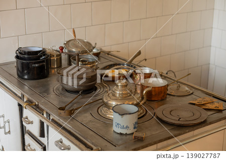 Antique Kitchen Stove With Copper Cookware And Traditional Frying Pan Cooking Scene Antique Kitchen Stove With Copper Cookware And Traditional Frying Pan Cooking Scene 139027787
