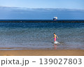 Active Boy Running In Sea Water Near Sandy Beach On Sunny Summer Day 139027803