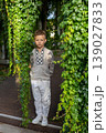 Confident Year Old Boy Standing Between Green Ivy Columns In Summer Garden Portrait 139027833