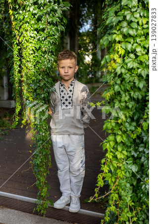 Confident Year Old Boy Standing Between Green Ivy Columns In Summer Garden Portrait Confident Year Old Boy Standing Between Green Ivy Columns In Summer Garden Portrait 139027833