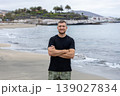 Confident Man Standing On Seaside Beach With Crossed Arms Travel Portrait 139027834