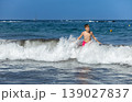 Young Boy Playing In Ocean Surf On Bright Sunny Summer Day 139027837