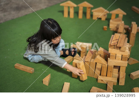 preschool child girl playing with wooden toy block at outdoor preschool child girl playing with wooden toy block at outdoor 139028995