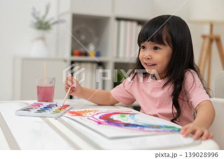 happy preschool child girl painting with watercolor on paper happy preschool child girl painting with watercolor on paper 139028996