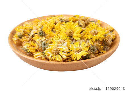 Dried Chrysanthemum flower tea in wooden bowl isolated on white background 139029048
